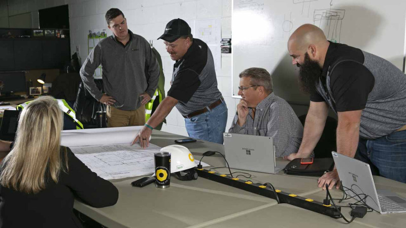 CBC team discussing plans in an office.